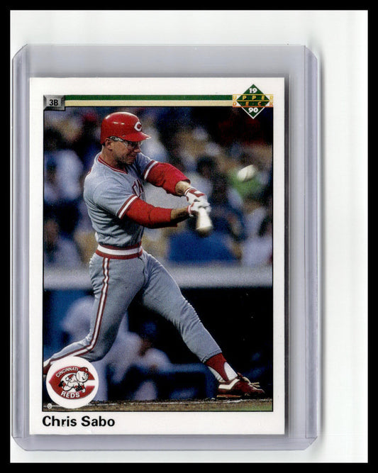 Baseball trading card of Chris Sabo in a gray uniform with red accents, held in a protective case.