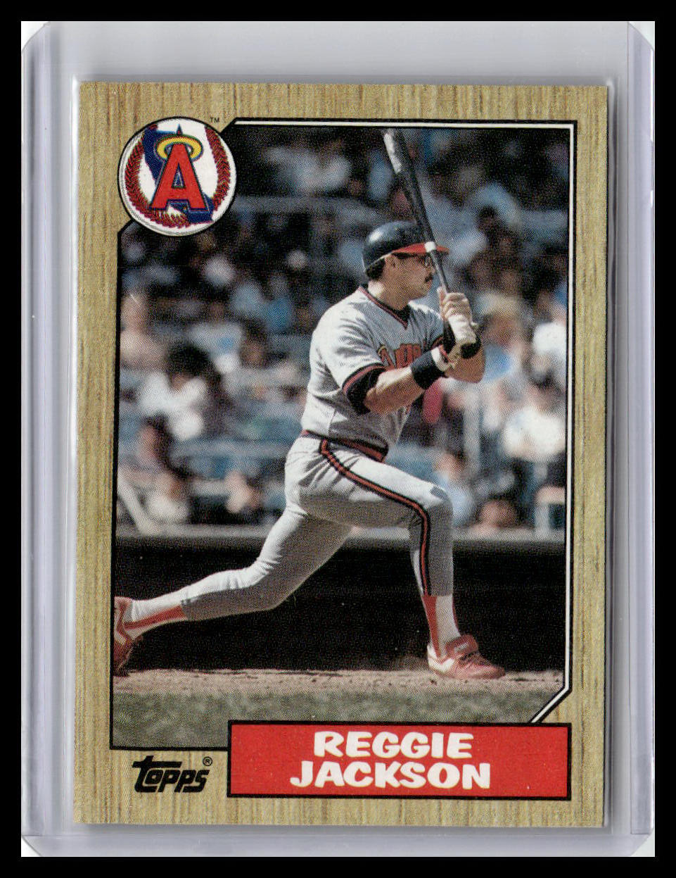 Baseball trading card of Reggie Jackson in a batting stance with a wooden border and Topps logo.