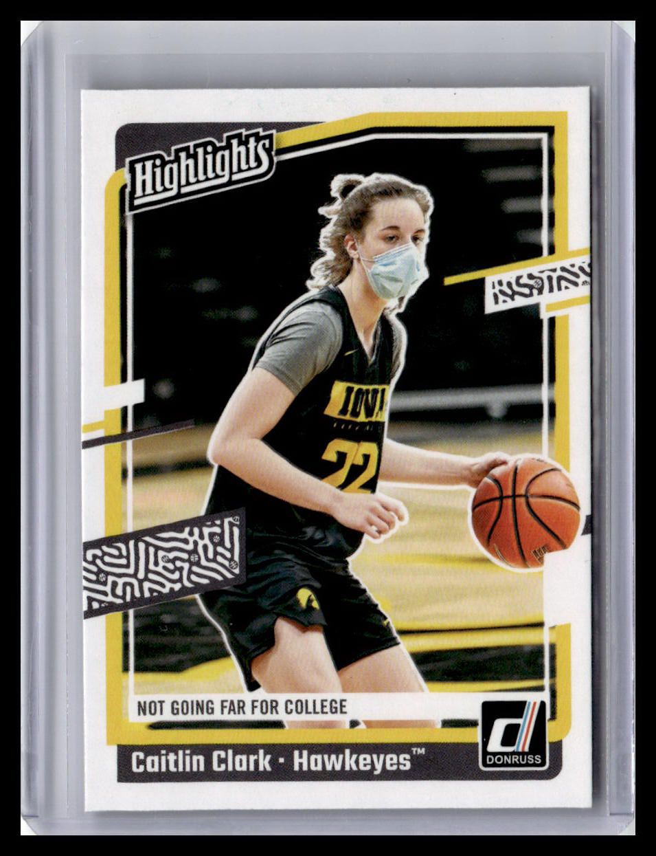 Basketball trading card of a player in a black and yellow uniform with a basketball, wearing a face mask.