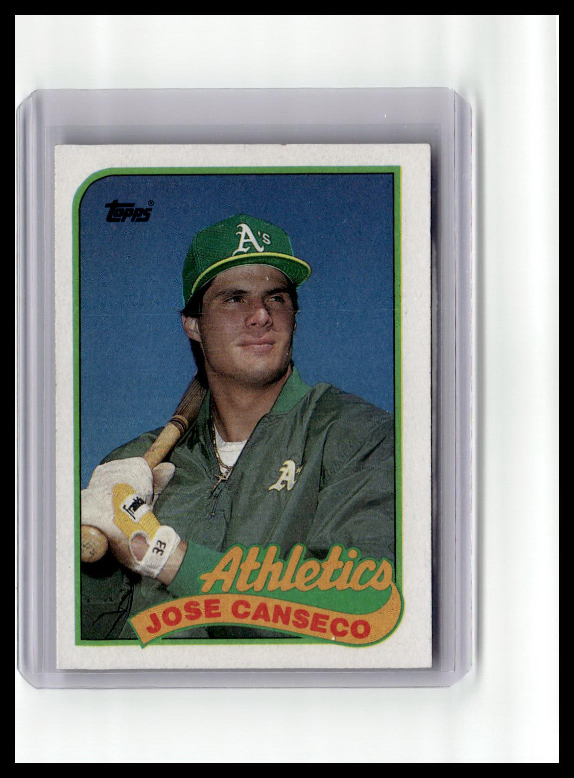 Baseball trading card of Jose Canseco with a green cap and jacket, featuring the Athletics logo.