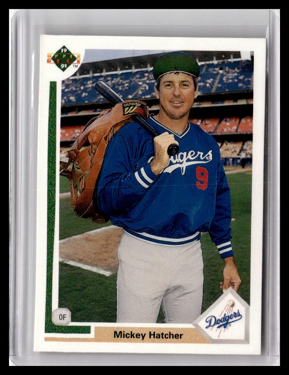 Baseball trading card of Mickey Hatcher holding a glove and bat on a field background