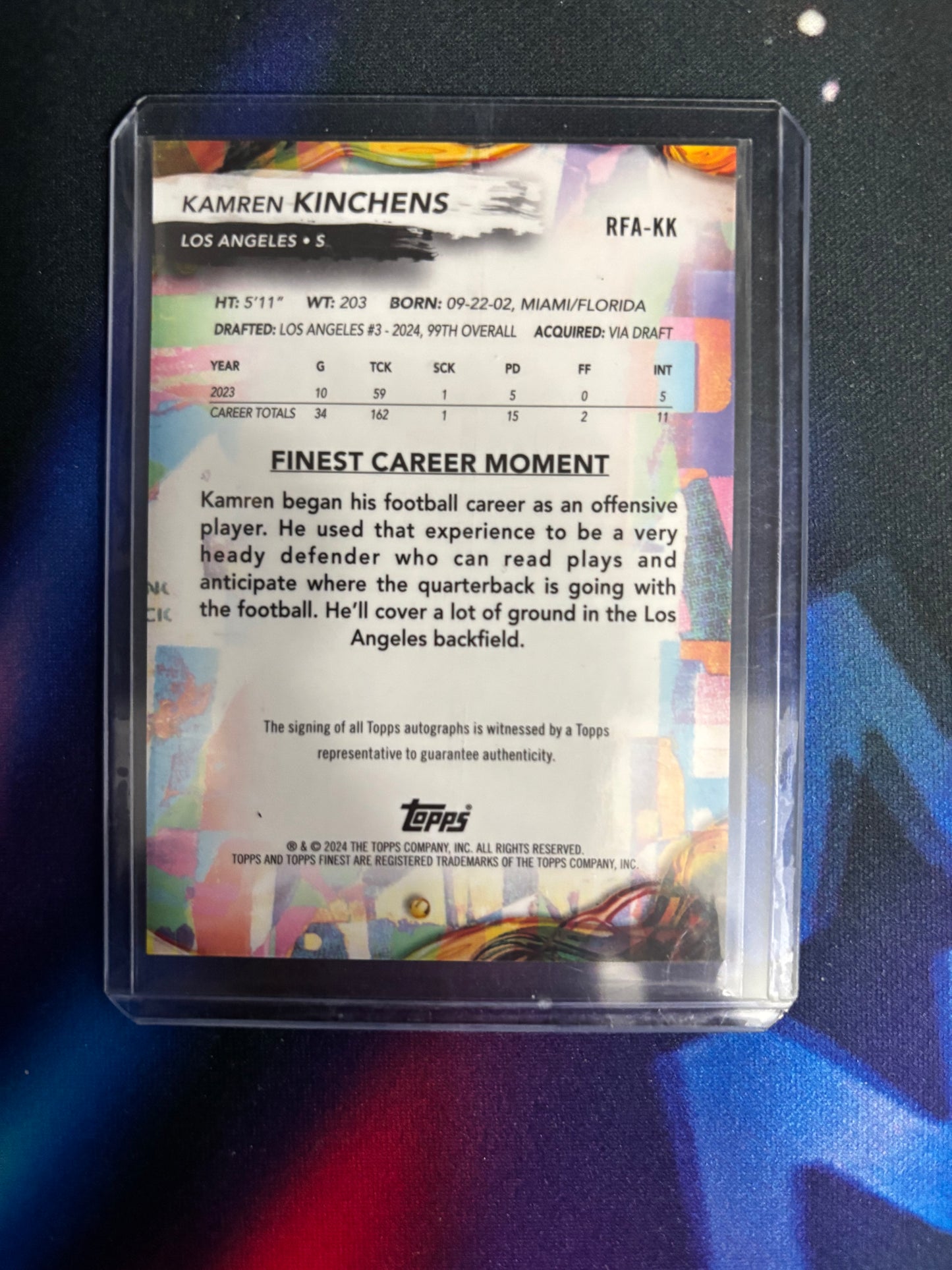 Trading card of Kamren Kinchens with colorful design and text on a dark background