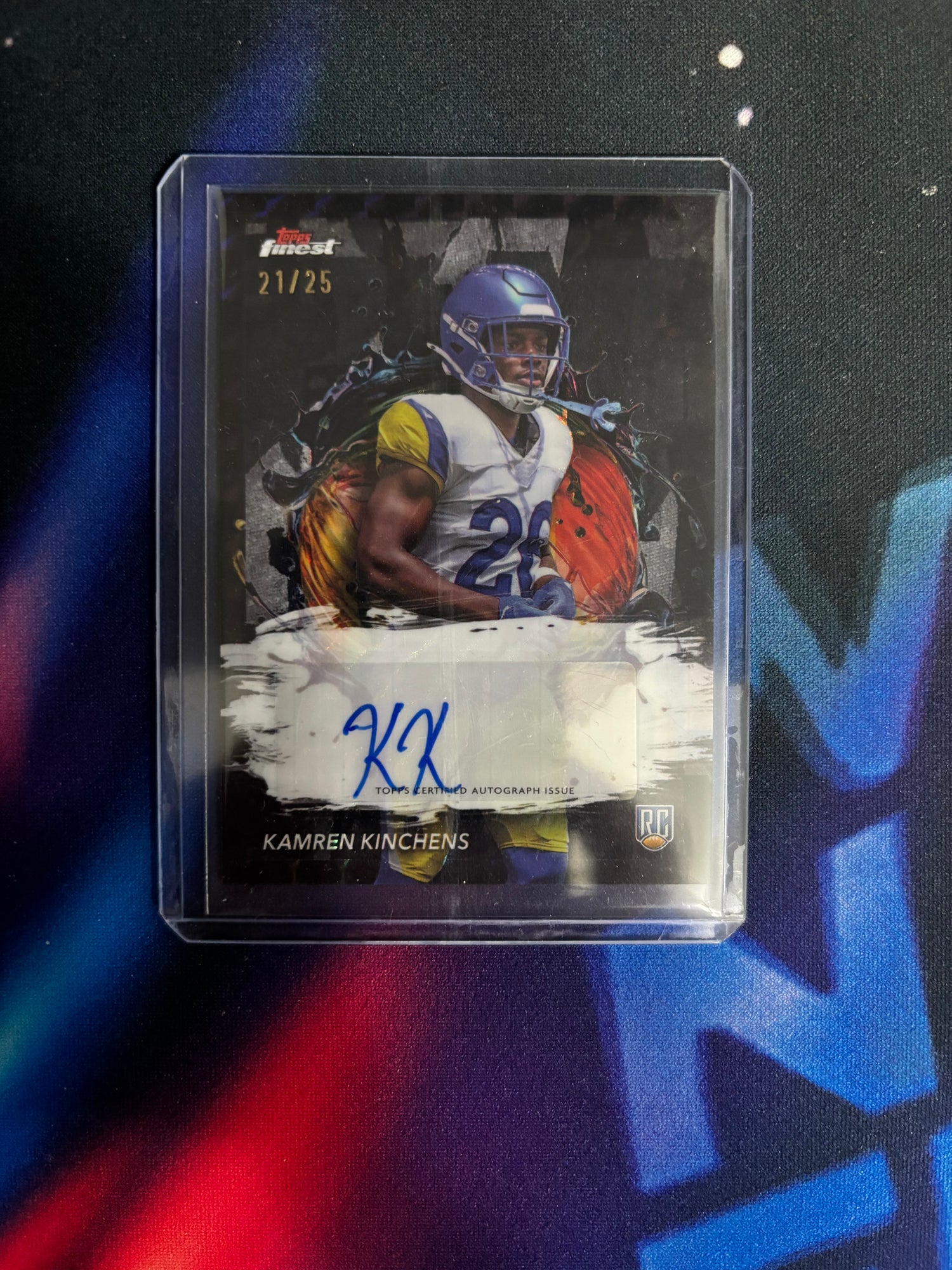 Collectible sports trading card of a football player in a clear protective case on a dark background.